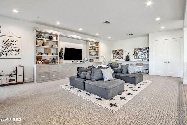 living room featuring recessed lighting, visible vents, and light colored carpet