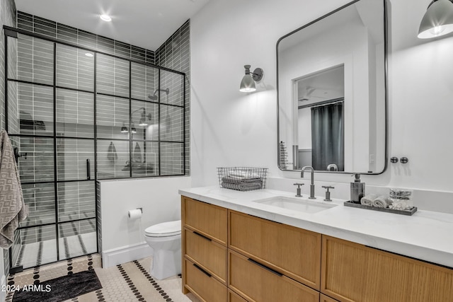 full bath with a shower stall, vanity, toilet, and tile patterned floors