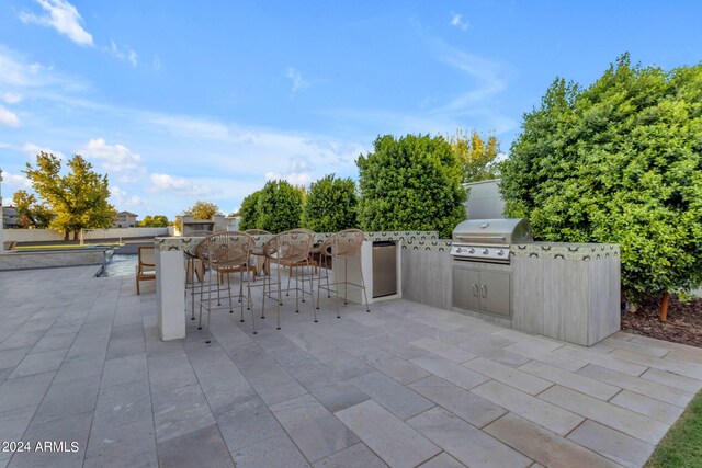 view of patio / terrace featuring a grill and exterior kitchen