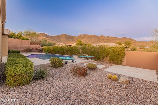 view of pool with a mountain view and a patio area