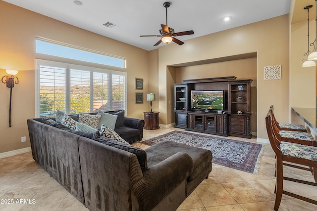 tiled living room with ceiling fan