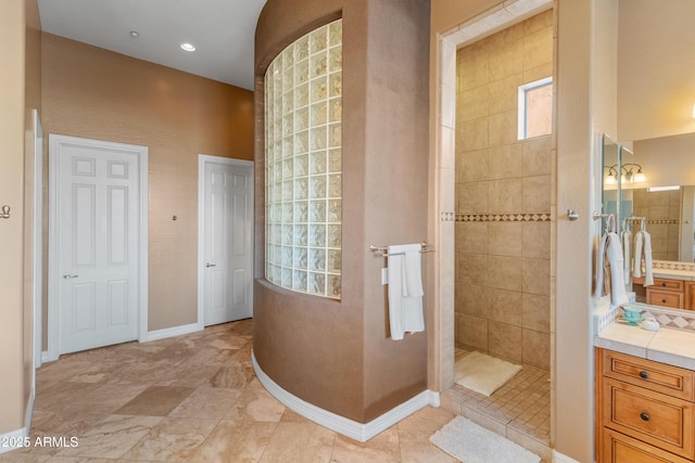 bathroom featuring vanity and tiled shower