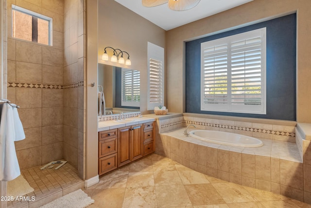 bathroom with plenty of natural light, shower with separate bathtub, ceiling fan, and vanity