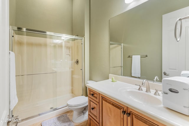 bathroom featuring toilet, tile patterned flooring, an enclosed shower, and vanity