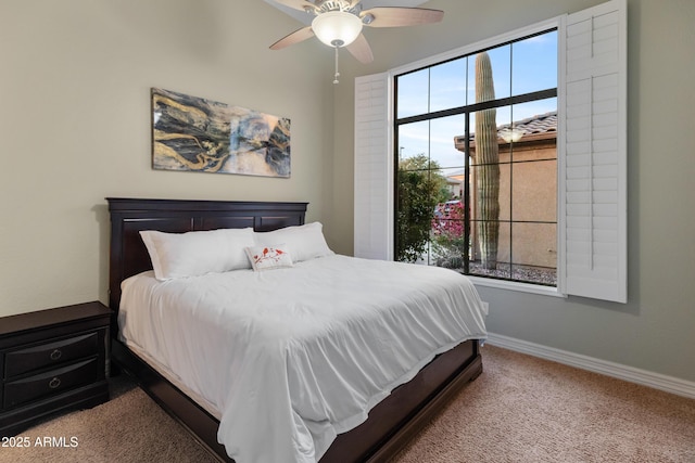 bedroom with ceiling fan, carpet floors, and multiple windows