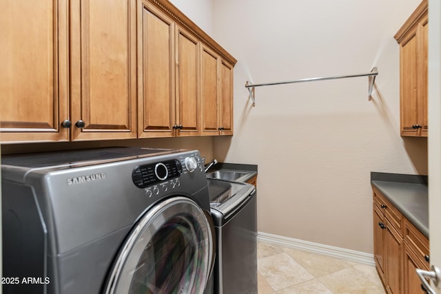 clothes washing area with washer and clothes dryer, cabinets, light tile patterned floors, and sink