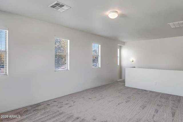 unfurnished room with light colored carpet