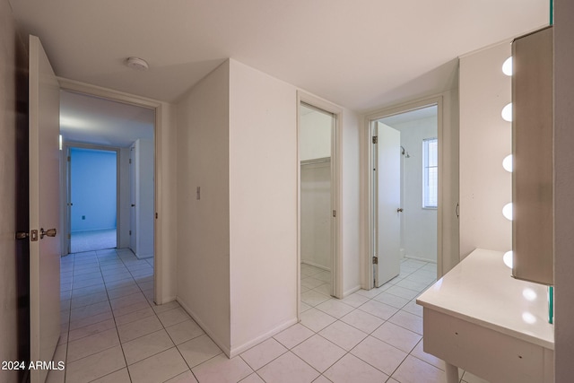 corridor featuring light tile patterned floors