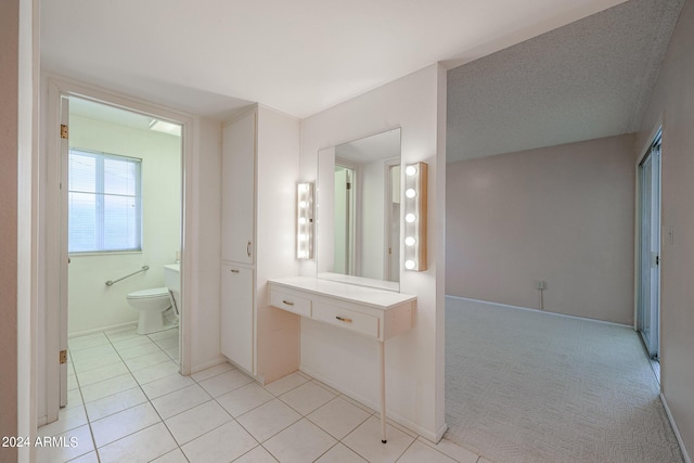 bathroom featuring tile patterned flooring, toilet, and a textured ceiling