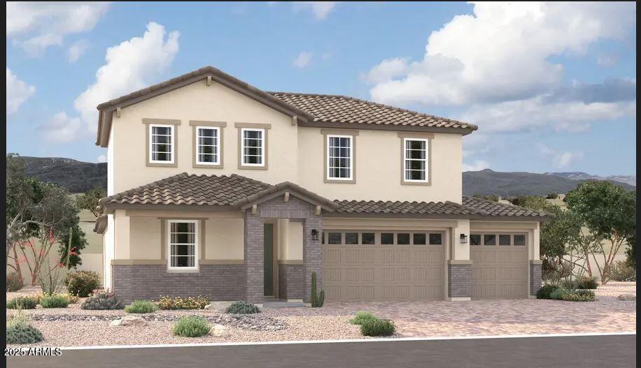 mediterranean / spanish-style house featuring a mountain view, brick siding, a tile roof, decorative driveway, and stucco siding