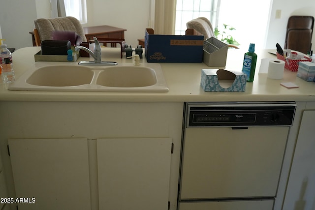 kitchen featuring white cabinetry, white dishwasher, and sink