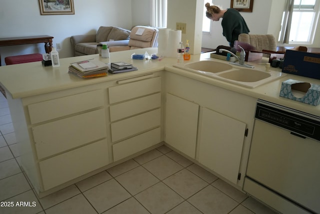 kitchen featuring light tile patterned flooring, sink, white dishwasher, and kitchen peninsula