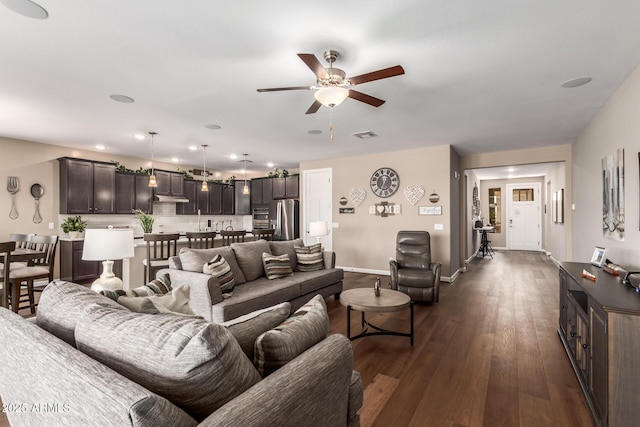 living room featuring dark hardwood / wood-style floors and ceiling fan