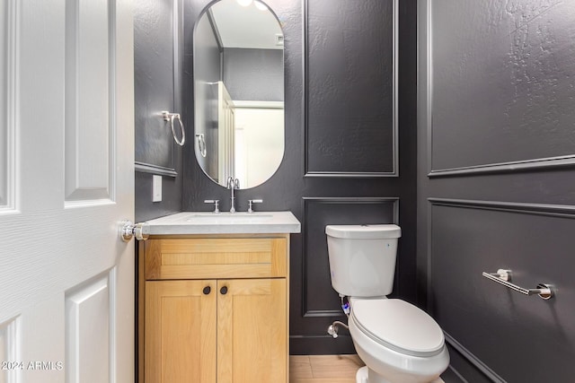 bathroom with toilet and vanity