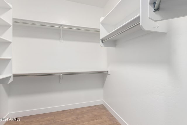 spacious closet with wood finished floors