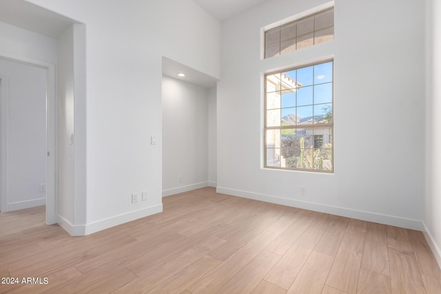 spare room with light wood finished floors and baseboards