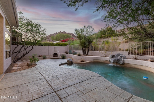 view of swimming pool with a fenced backyard, a patio area, and a fenced in pool