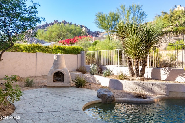 exterior space with a patio, a mountain view, and a fenced backyard
