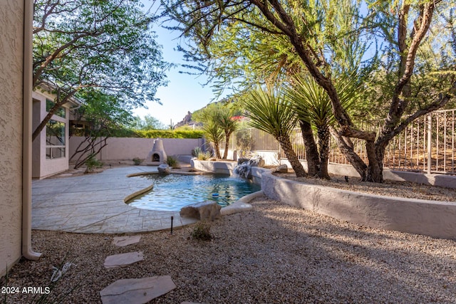 view of swimming pool featuring a patio, a fenced in pool, and a fenced backyard