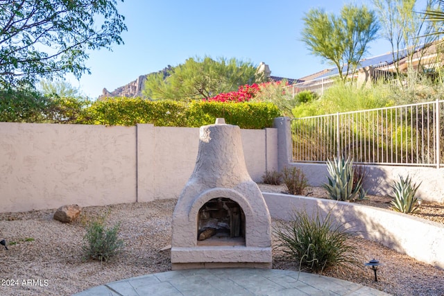view of patio with a mountain view and fence