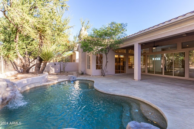 view of pool with a patio area, a fenced in pool, ceiling fan, and fence