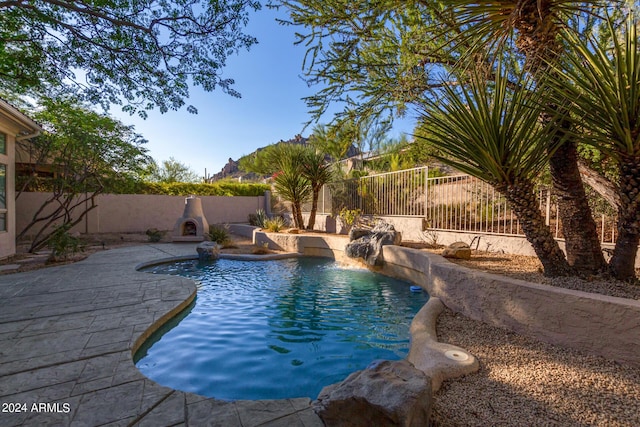 view of swimming pool featuring a patio, a fenced in pool, and a fenced backyard