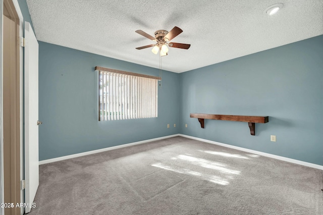 unfurnished room featuring carpet, a textured ceiling, and ceiling fan