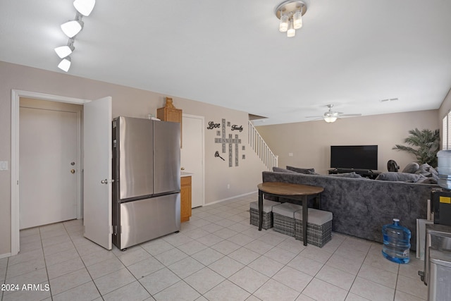 kitchen with ceiling fan, light tile patterned floors, and stainless steel refrigerator