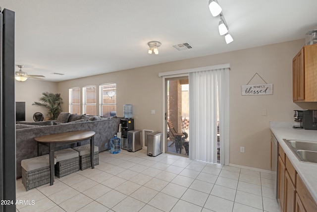 kitchen featuring stainless steel dishwasher, ceiling fan, and light tile patterned flooring