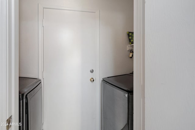 clothes washing area with washing machine and clothes dryer