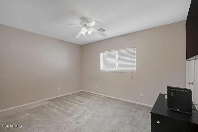 unfurnished office featuring light colored carpet and ceiling fan