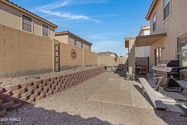 view of patio featuring a grill