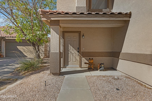 doorway to property with a garage