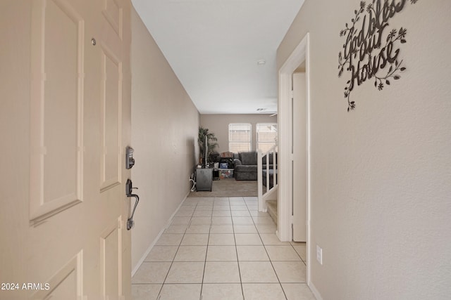 hall with light tile patterned floors