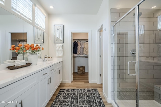644 N Vine St, Chandler, AZ 85225 - bathroom featuring double vanity, wood finished floors, a spacious closet, a shower stall, and recessed lighting