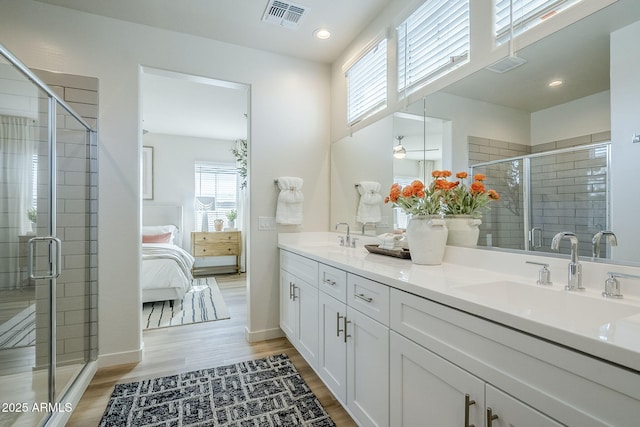 644 N Vine St, Chandler, AZ 85225 - ensuite bathroom with double vanity, a stall shower, wood finished floors, and recessed lighting