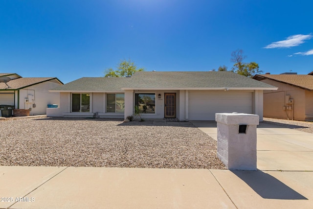 ranch-style home with stucco siding, a garage, concrete driveway, and a shingled roof