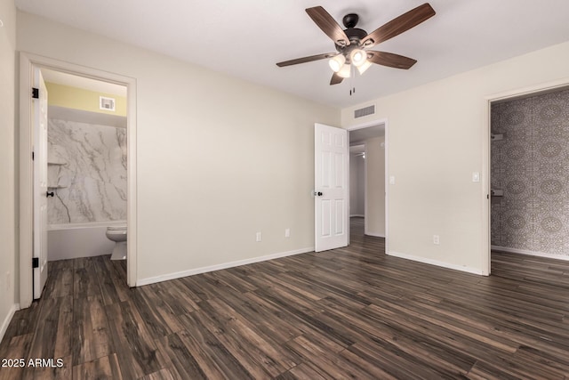 unfurnished bedroom featuring dark wood-style floors, visible vents, and baseboards