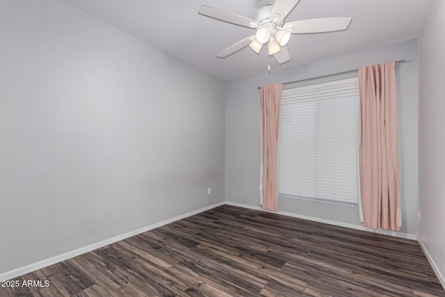 unfurnished room featuring baseboards, dark wood-type flooring, and ceiling fan