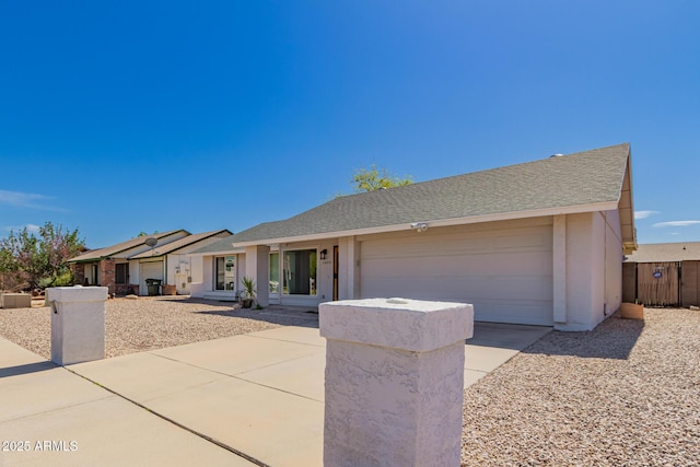 ranch-style home featuring stucco siding, an attached garage, concrete driveway, and roof with shingles