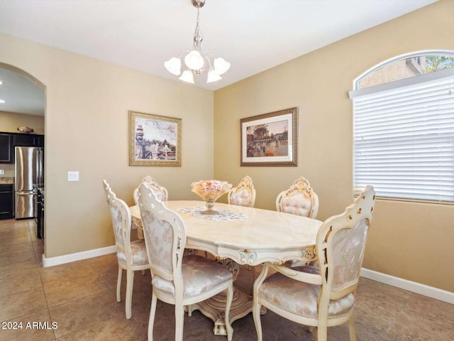 dining room with an inviting chandelier and light tile patterned floors