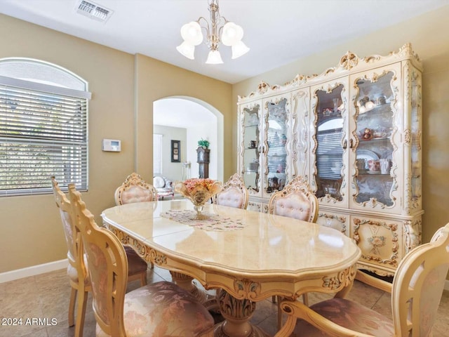 dining area featuring a chandelier and light tile patterned floors