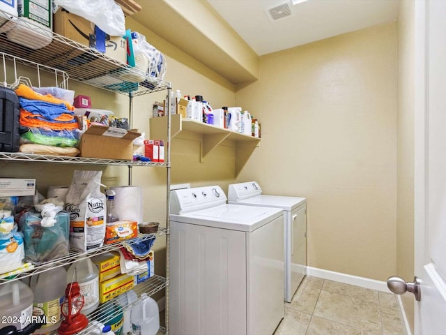 washroom featuring light tile patterned floors and washer and dryer