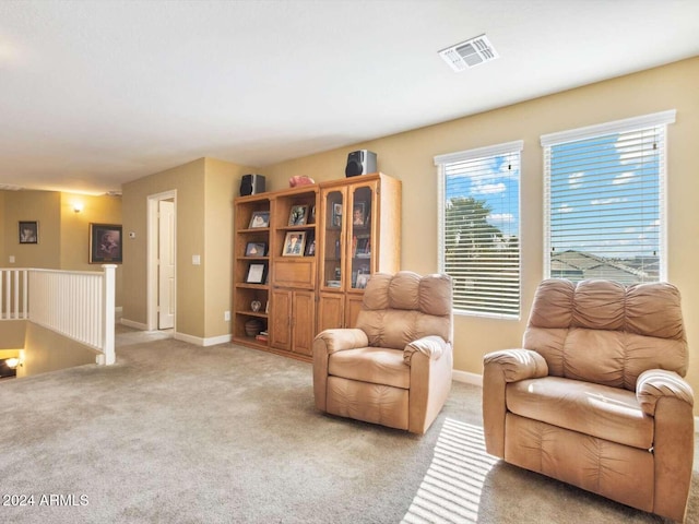 sitting room featuring light colored carpet