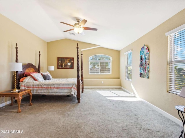 carpeted bedroom featuring multiple windows, vaulted ceiling, and ceiling fan