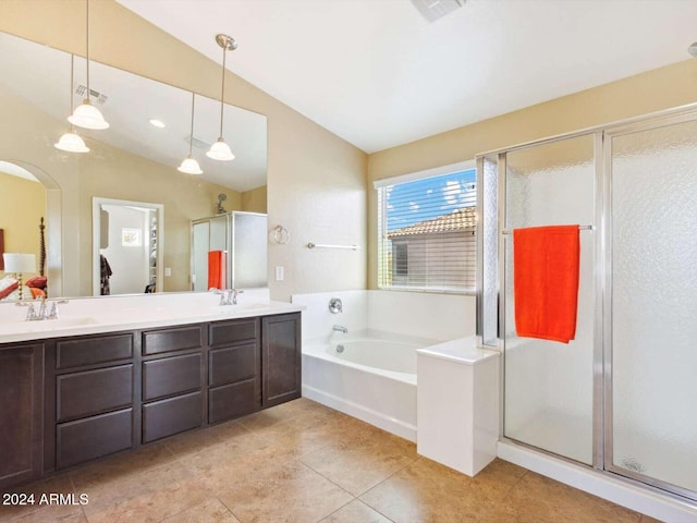 bathroom featuring shower with separate bathtub, lofted ceiling, tile patterned floors, and vanity