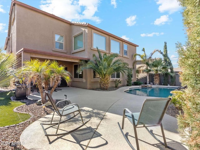 back of house with a patio and a fenced in pool