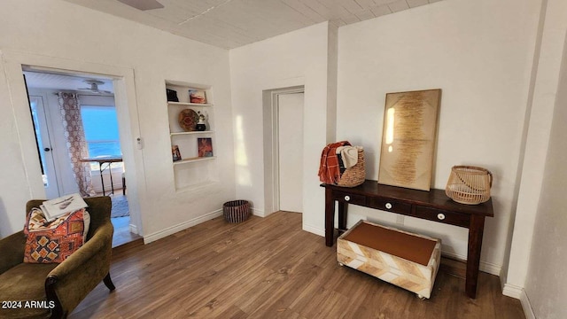 misc room with built in features and dark wood-type flooring