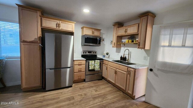 110 N Pinal Ave, Superior, AZ 85173 - kitchen featuring light brown cabinetry, stainless steel appliances, light hardwood / wood-style flooring, and sink