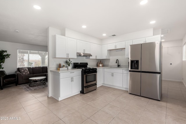 kitchen featuring white cabinetry, appliances with stainless steel finishes, light tile patterned flooring, and sink